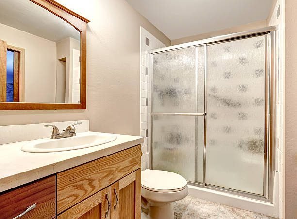 Small bathroom with sliding glass shower door for open layout.